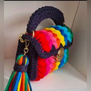Handmade from recycled cotton, this handbag is trendy, attractive and unique.